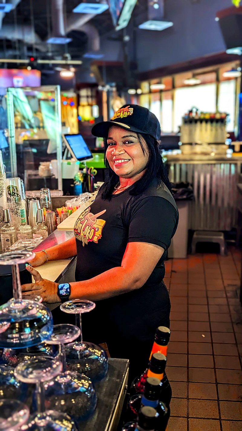 Bartender smiling behind the bar