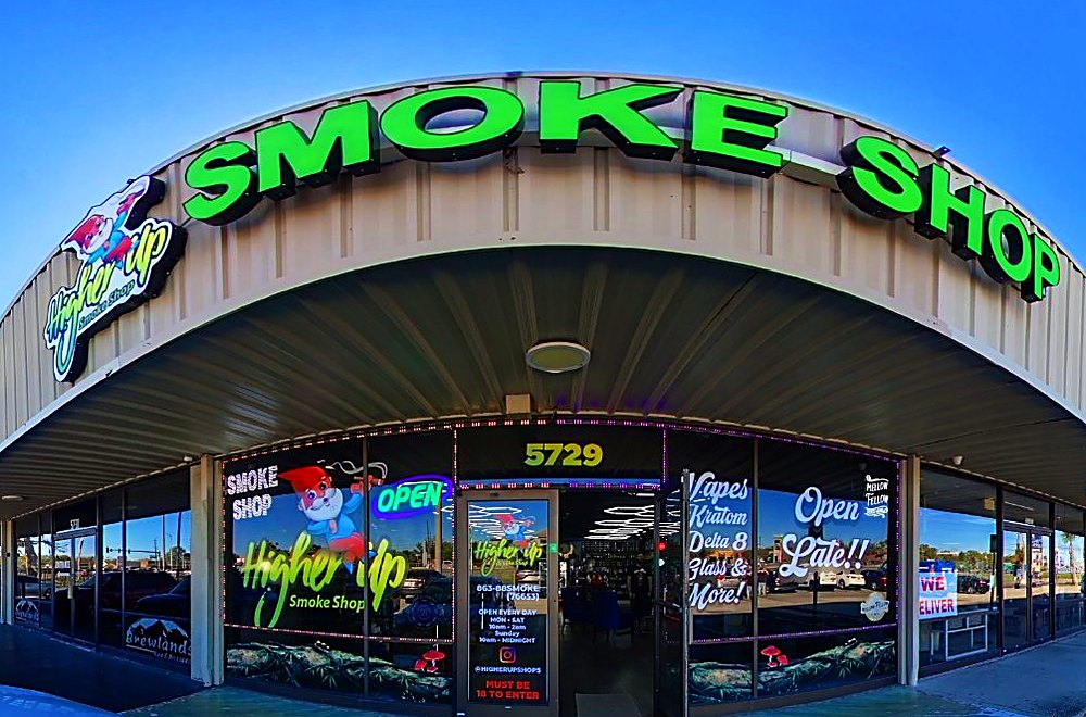 Smoke shop entrance with green sign